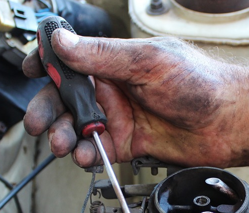 Mechanic fixing car.